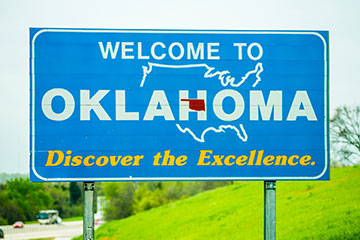 A blue Welcome to Oklahoma road sign